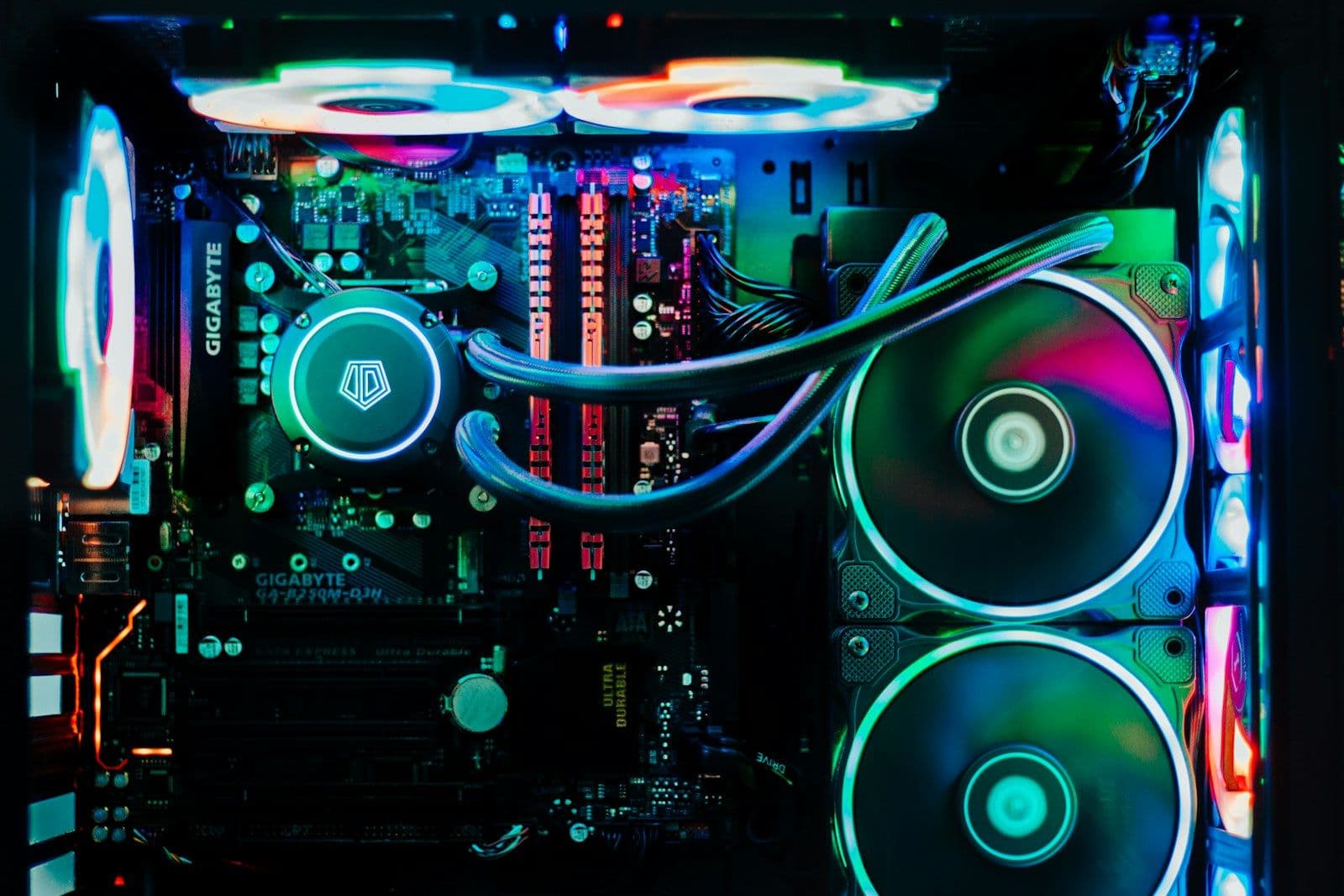 A motherboard and two rainbow-lit cooling fans inside a case